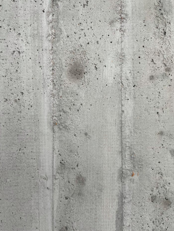 Detailed shot of a rough concrete wall texture, ideal for backgrounds.